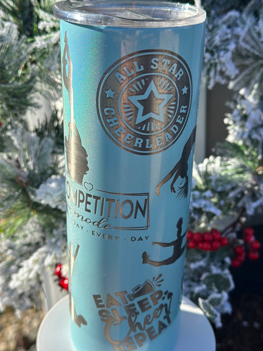 May include: A light blue tumbler with a silver design. The tumbler has a silver circle with the words &#39;All Star Cheerleader&#39; and a star inside. The tumbler also has a silver rectangle with the words &#39;Competition Mode&#39; and &#39;Every Day&#39;. The tumbler also has a silver design of a cheerleader doing a stunt and the words &#39;Eat Sleep Cheer Repeat&#39;.